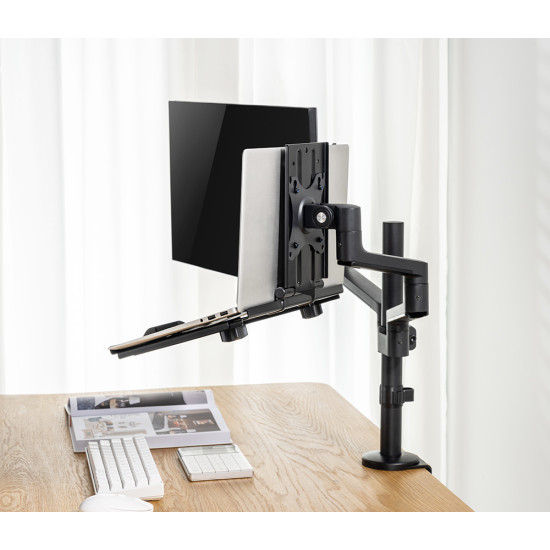 UVI black laptop and tablet tray attached to a VESA monitor arm, shown holding a laptop with adjustable depth and height settings