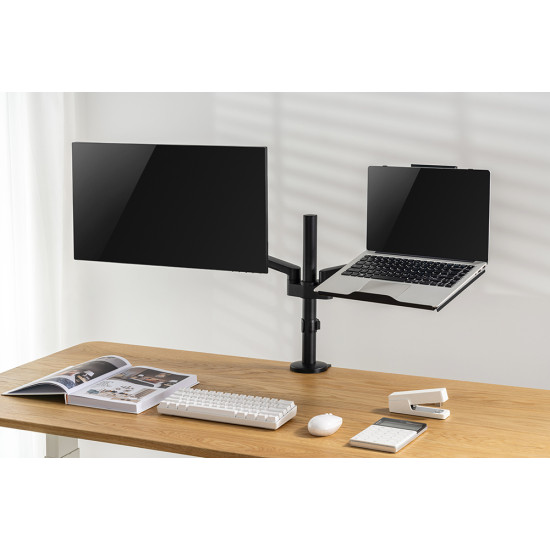UVI black laptop and tablet tray attached to a VESA monitor arm, shown holding a laptop with adjustable depth and height settings