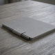 reMarkable Paper Pro + Marker Plus + Book Folio Gray reMarkable Paper Pro tablet in Polymer Weave Gray with Marker Plus stylus and Book Folio cover, open and viewed from above on a desk