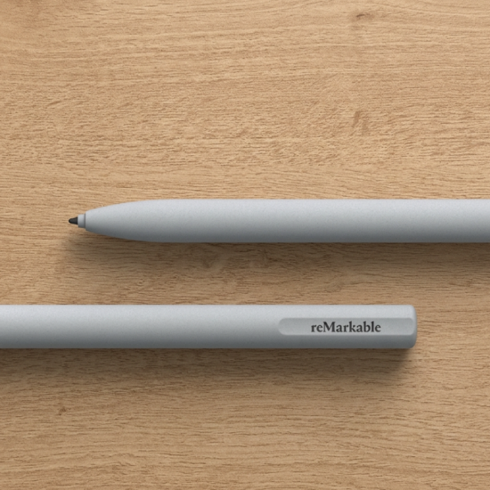 reMarkable 2 Marker stylus in white with slim matte finish, shown next to the reMarkable 2 tablet on a white background
