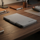 reMarkable Paper Pro Move + Marker Plus + Book Folio Grey reMarkable Paper Pro Move digital paper tablet with Marker Plus stylus and grey Book Folio cover, open on a desk