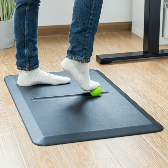 UVI Anti-Fatigue Standing Desk Mat UVI Anti-Fatigue Mat with massage ball on a hard floor in a standing desk workplace setting